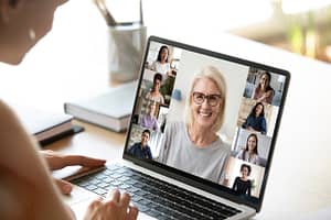 Diverse woman involved in group videocall, laptop screen view